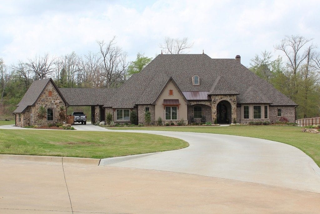 A stone and brick custom home designed by Bostock Drafting & Design, built in East Texas