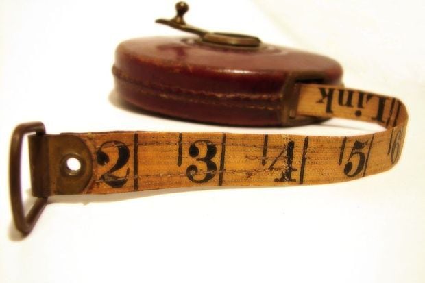 An antique cloth measuring tape, a nod to six decades of measured drawings